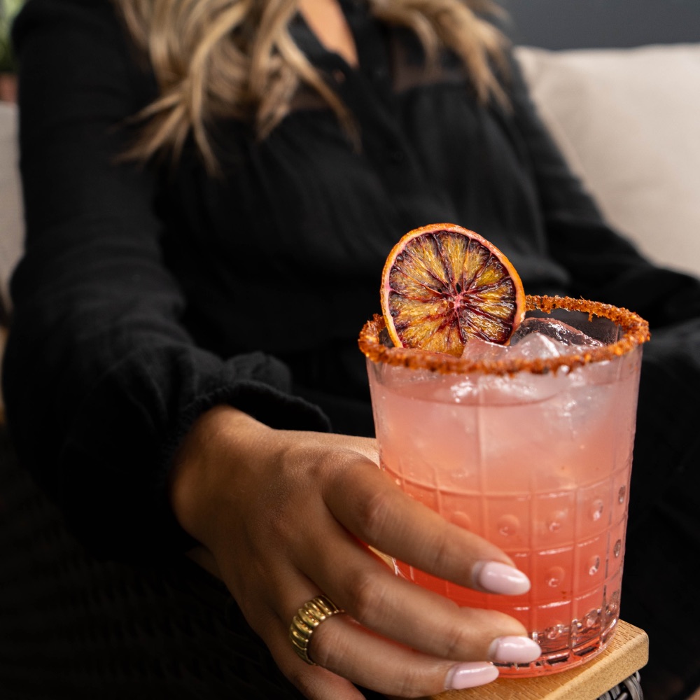 A chili-rimmed margarita with a dried orange wheel