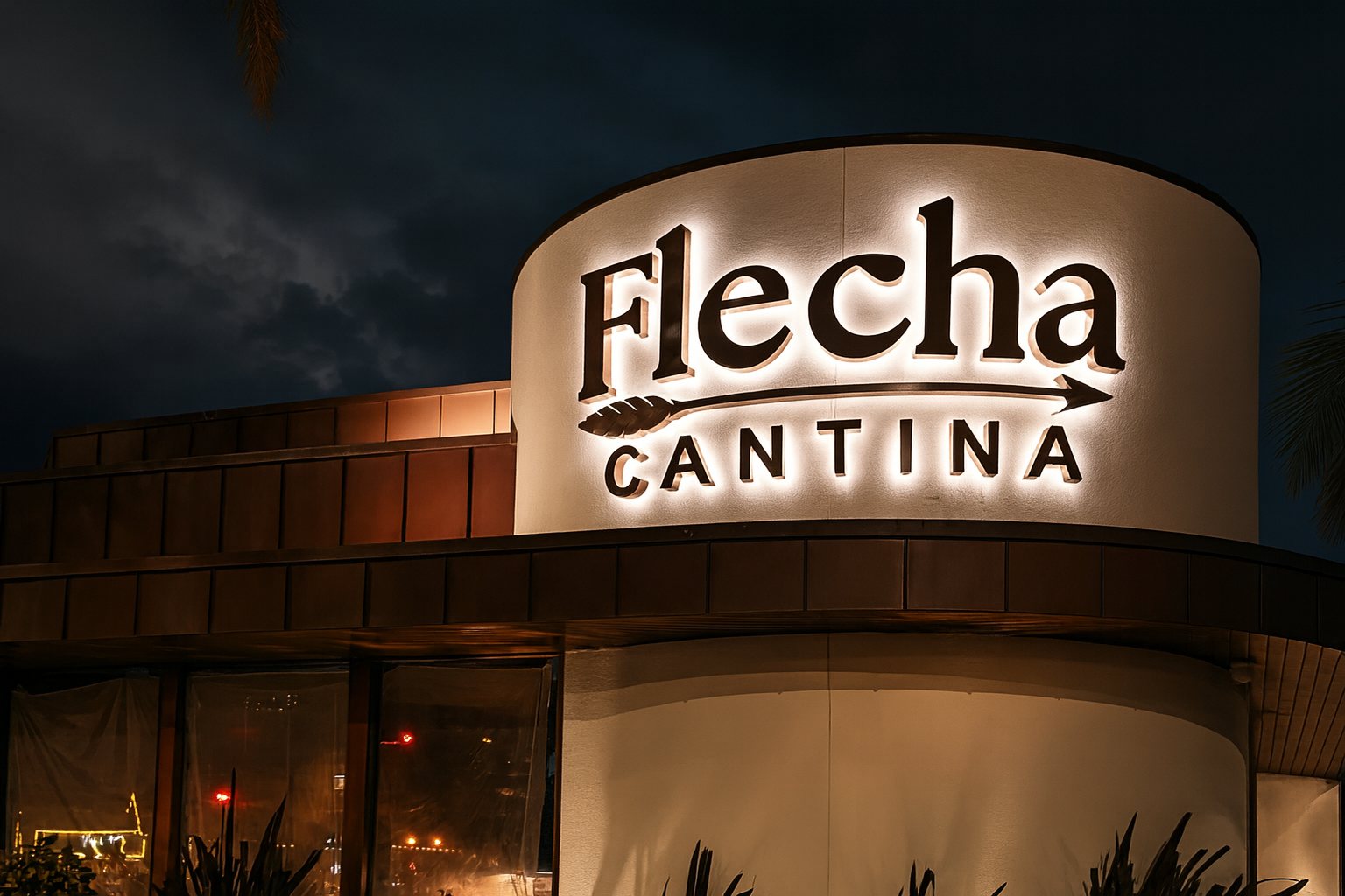 Flecha Cantina Newport Beach at night, its sign glowing